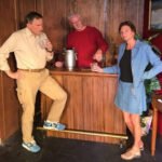 a man and woman standing in front of a bar having a drink - bartender behind the bar pouring a drink - my husbands wild desires